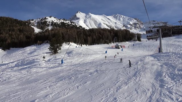 Chairlift on ski slope in Valle d'Aosta, Pila, Italy