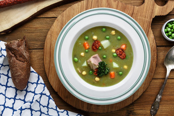 Hearty traditional Dutch pea soup with smoked sausage, rye bread and bacon. Or: 'erwtensoep met rookworst, roggebrood en spek'.