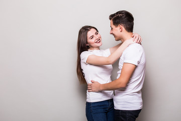 Couple hugging on  gray background