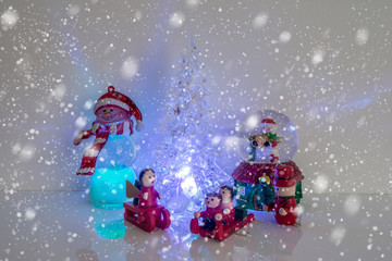 Christmas tree with wooden toys on snow