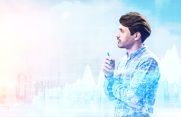 Man with marker looks at graphs in city