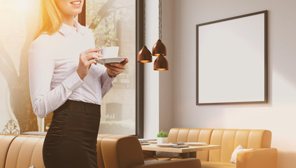 Woman in a cafe with poster