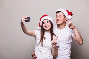 Happy xmas couple taking selfie on phone