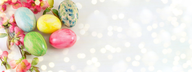 Fototapeta na wymiar Painted Easter eggs and Japanese rose flowers