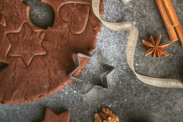 cutting gingerbread cookie with cinnamon and ribbon for Christmas