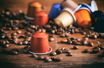 Colorful espresso capsules on wooden background