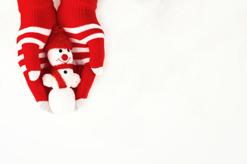 Christmas card, gloves on hands holding a snowman isolated on a