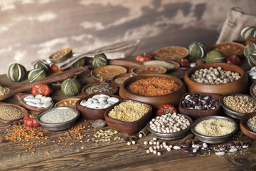 Healthy food and diet theme. Lentils, peas, beans, protein food in bowls, on a wooden table.