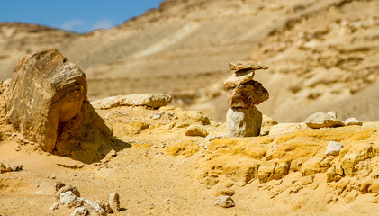 Pyramid of rough stones on foreground in Negev desert