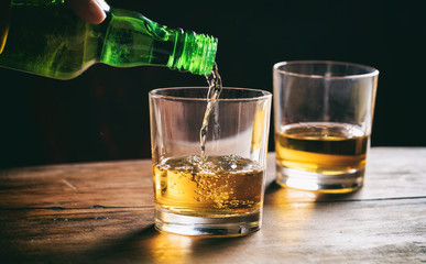 Glasses of whiskey on a wooden table