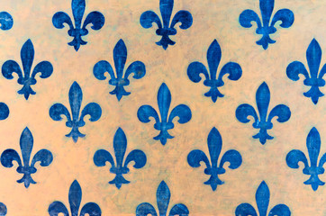 Majestic blue Fleur-de-lis pattern painted on a wall in Palazzo Vecchio - a museum in Florence, Italy © ifeelstock