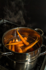 Carrots being steamed on cooker.