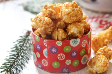 Caramel popcorn on holiday background, selective focus