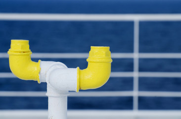 Nautical equipment of the ferry boat deck - yellow pipe and whit - 129828353