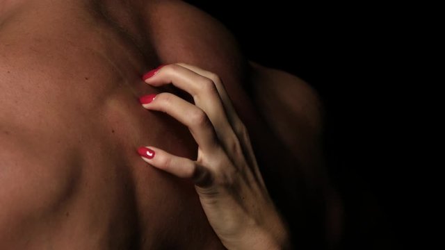 Sex - Woman's hands plunging her nails into her muscular partner's back