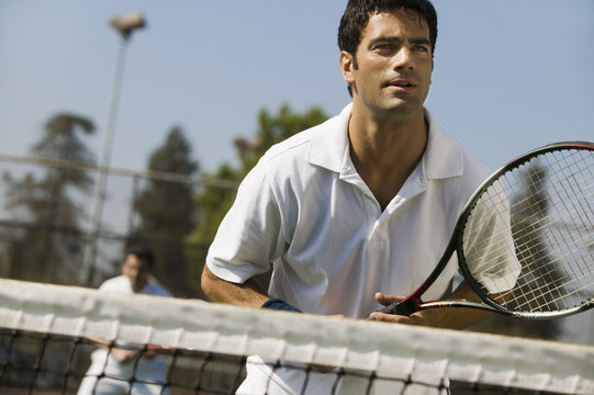 Male Doubles Tennis Players Waiting For Serve Front View Focus On Foreground