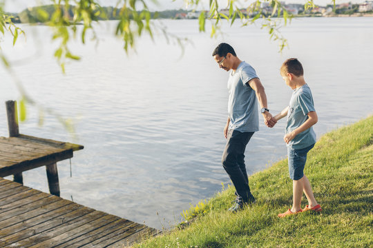 Sweden, Blekinge, Karlskrona, Father and son (8-9) by lake