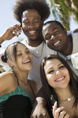 Four friends with mobile phones portrait