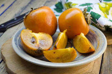 Naklejka na ściany i meble ripe persimmon on a plate