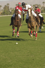 Three polo players in action during tournament