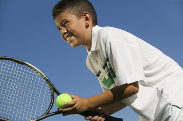 Young boy on tennis court Preparing to Serve close up low angle view