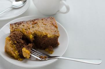 Caramel Peanut-Topped Brownie Cake with A Cup of Tea.