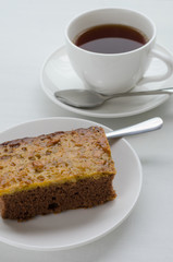 Caramel Peanut-Topped Brownie Cake with A Cup of Tea.