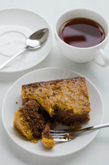 Caramel Peanut-Topped Brownie Cake with A Cup of Tea.