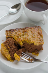 Caramel Peanut-Topped Brownie Cake with A Cup of Tea.
