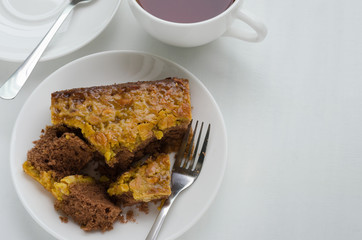 Caramel Peanut-Topped Brownie Cake with A Cup of Tea.