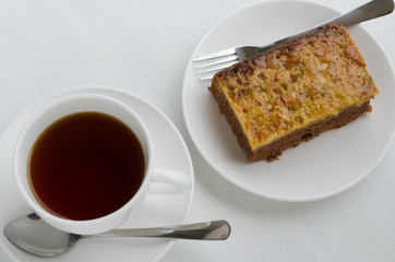 Caramel Peanut-Topped Brownie Cake with A Cup of Tea.