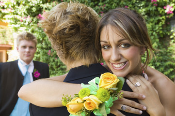 Well-dressed teenagers hugging outside © MDBPIXS