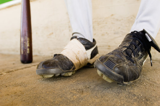 Closeup low section of a baseball player with focus on shoes