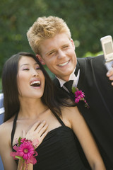 Well-dressed teenagers taking photo with camera phone outside © MDBPIXS