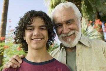 Boy (13-15) with Grandfather outdoors front view portrait.