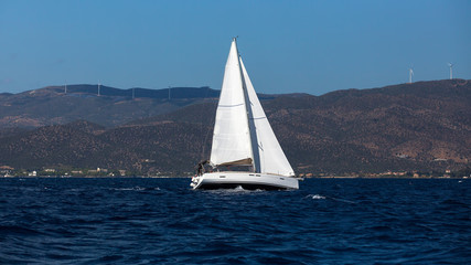 Fototapeta na wymiar Yacht boat at regatta. Sailing in the wind through the waves at the Sea.