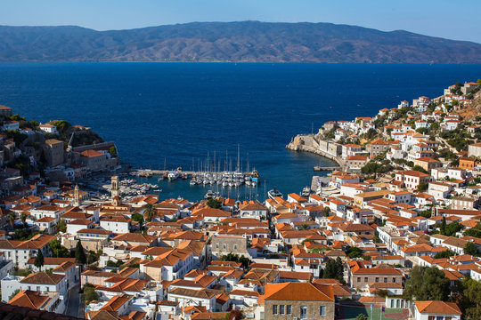 Top view on houses and yachts marina at Hydra island, Greece, Aegean sea.