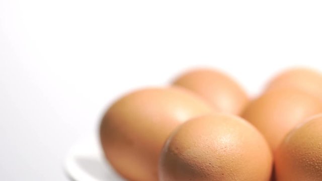 Rotating of egg on white background, Closeup shot
