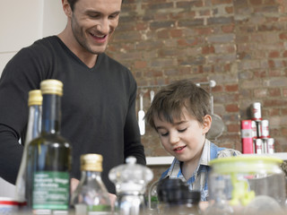 Happy father and son in kitchen