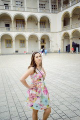 Beautiful girl during sightseeing old castle in Cracow, Wawel.