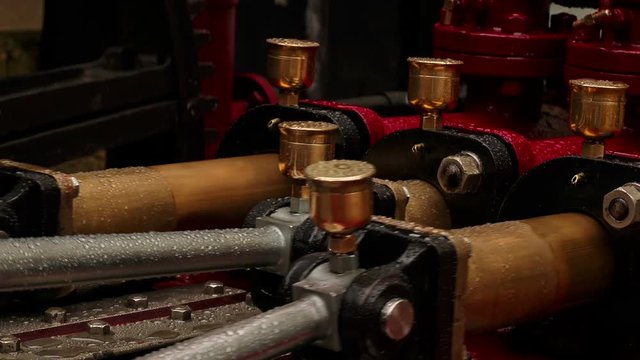 An ultra closeup view of three pistons of an outdoor hydraulic engine
