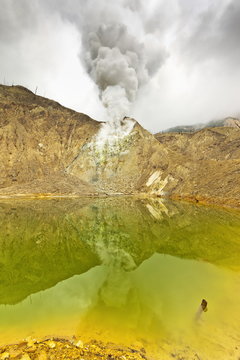 Green crater lake and steaming fumaroles at Papandayan Volcano, an active four cratered caldera, Garut, West Java, Java, Indonesia