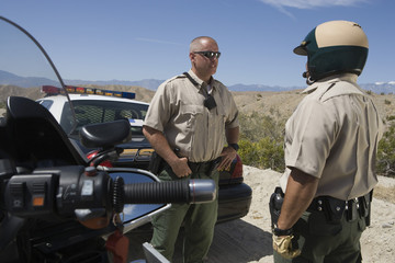 Male traffic officers having conversation with each other