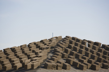 Stack of tiles on rooftop against clear sky