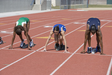 Multiethnic female athletes at starting line on race track