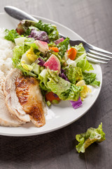 Italian salad with rotisserie chicken and white rice dinner on a plate
