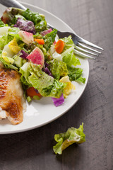 Italian salad with rotisserie chicken and white rice top view on dark wood