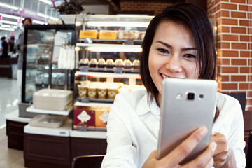 Asian women  look at the phone,