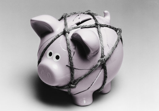 Broken piggy bank reassembled with twine
