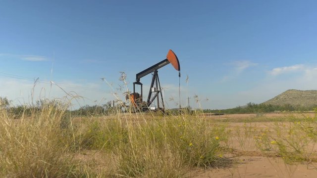 Industrial jack pump platform working on oil field in Texas